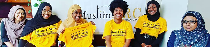 6 people sitting in front of a MuslimARC banner, smiling