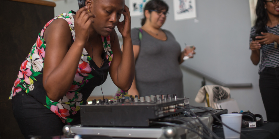 Nandi Comer DJing using a mixer