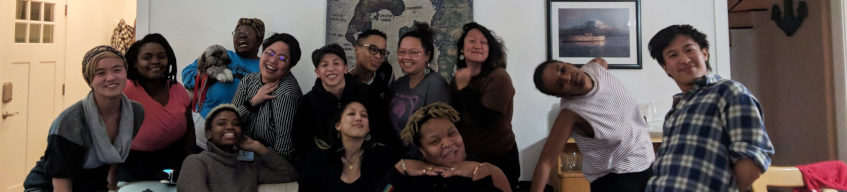 A group of Queer the Land members in a house