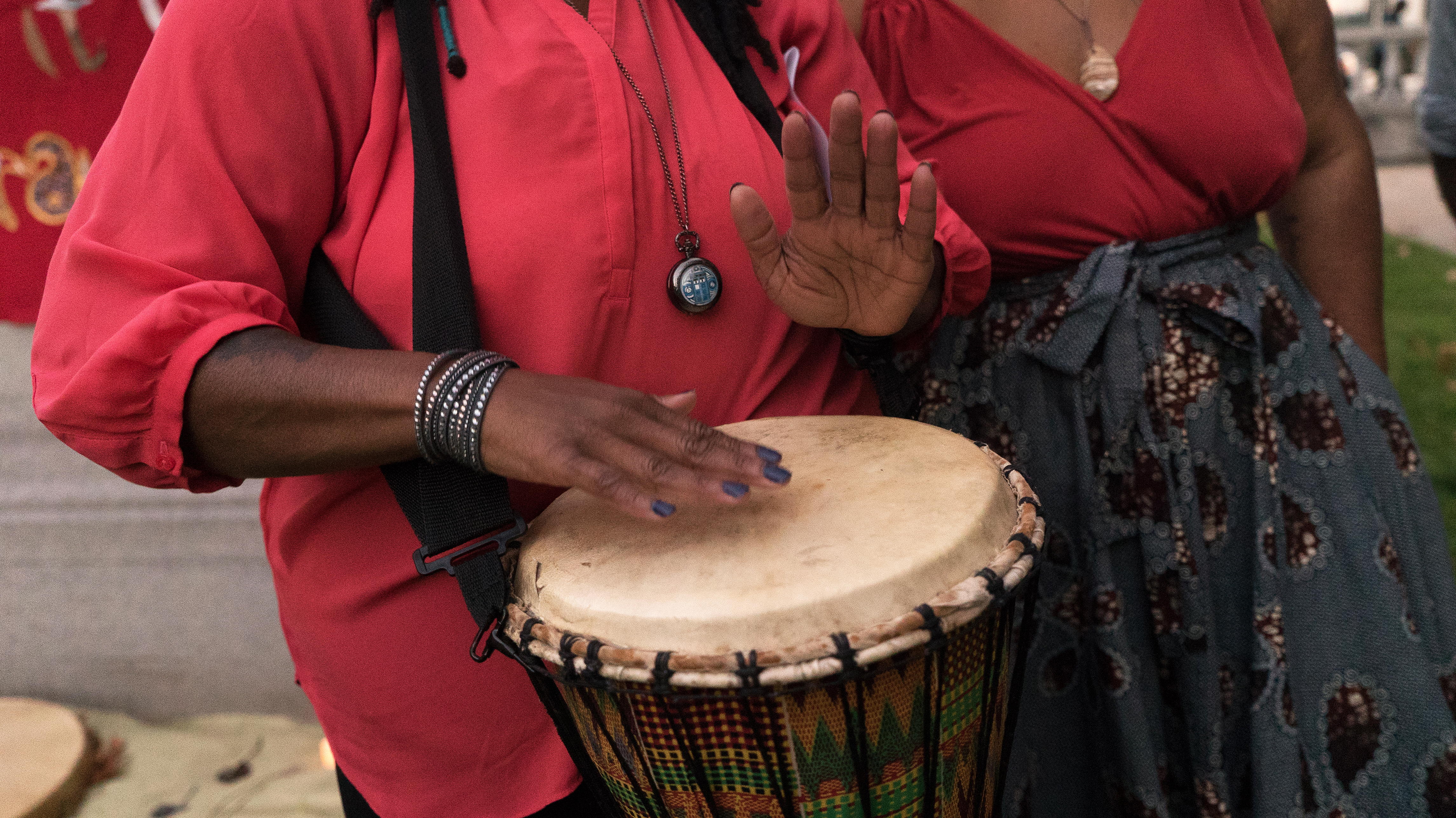 Black woman's hands playing a kimbe drum