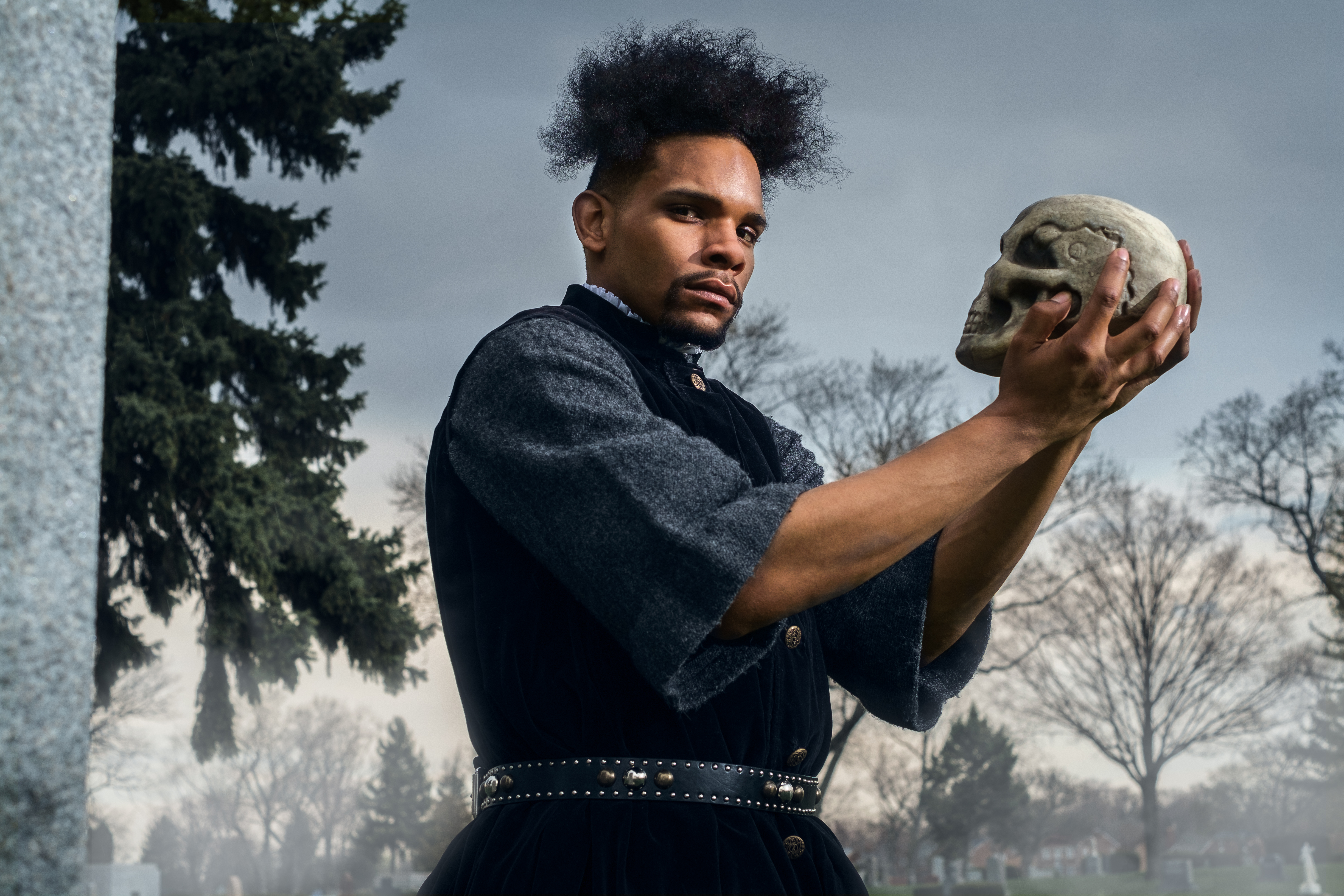 Actor holding skull in Shakespearean Hamlet production