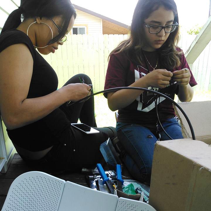 Two digital stewards working on wiring a house