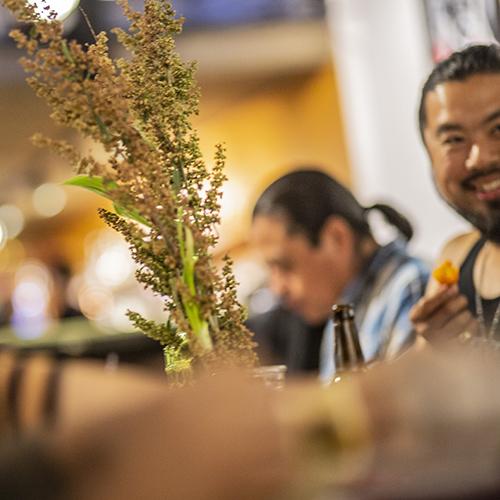 Vase of flowers, and people at AMC Dream Cafe